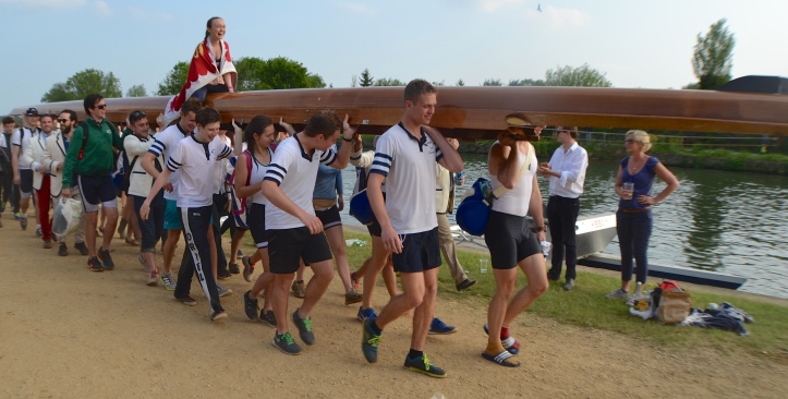 As is their custom, members of Oriel Boat Club carry the winning cox, wrapped in the college flag, on an old wooden eight along the row of boathouses, through the town and into college.